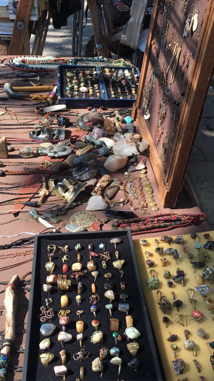 an assortment of jewelry is on display at the flea market