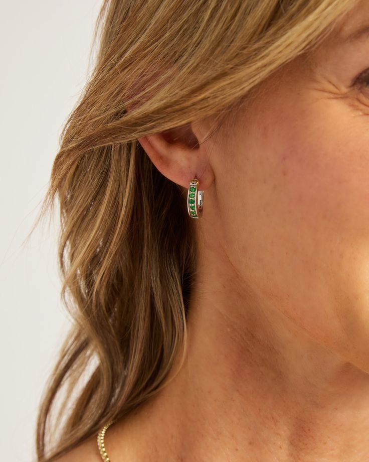 Our Stone Embellished Hoops feature a classic hoop shape decorated with green zircon stones and a signature 14K gold petroglyph. This style is perfect for everyday wear or formal occasions. Metal: Sterling silver with 14K gold accents Stone: Green zircon Dimensions: 16mm x 14mm Style #: E237Gz Green 14k Gold Hoop Earrings, Green Tarnish-resistant Jewelry For Anniversary, Everyday Luxury Green Jewelry, Ornate Yellow Gold Emerald Hoop Jewelry, Tarnish Resistant Emerald Jewelry, Timeless Tsavorite Green Jewelry, Green Channel Set Jewelry For Formal Events, Formal Emerald Channel Set Jewelry, Fine Jewelry With Channel Set Green Stones