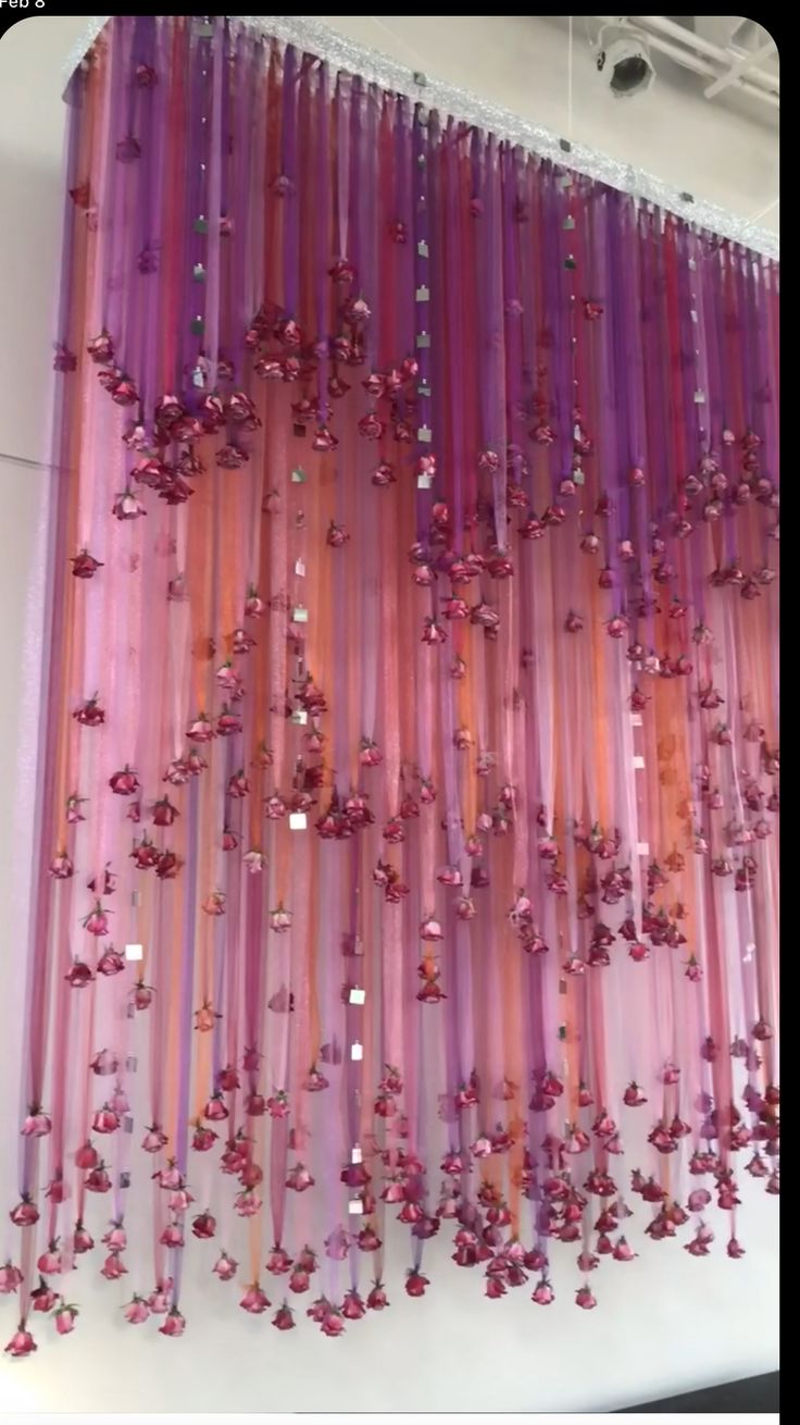 purple and pink curtains hanging from the ceiling