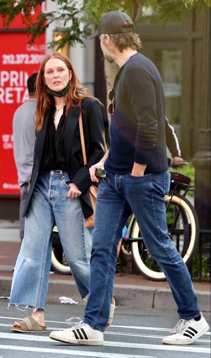 a man and woman walking down the street