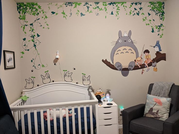 a child's room with a totoro mural on the wall