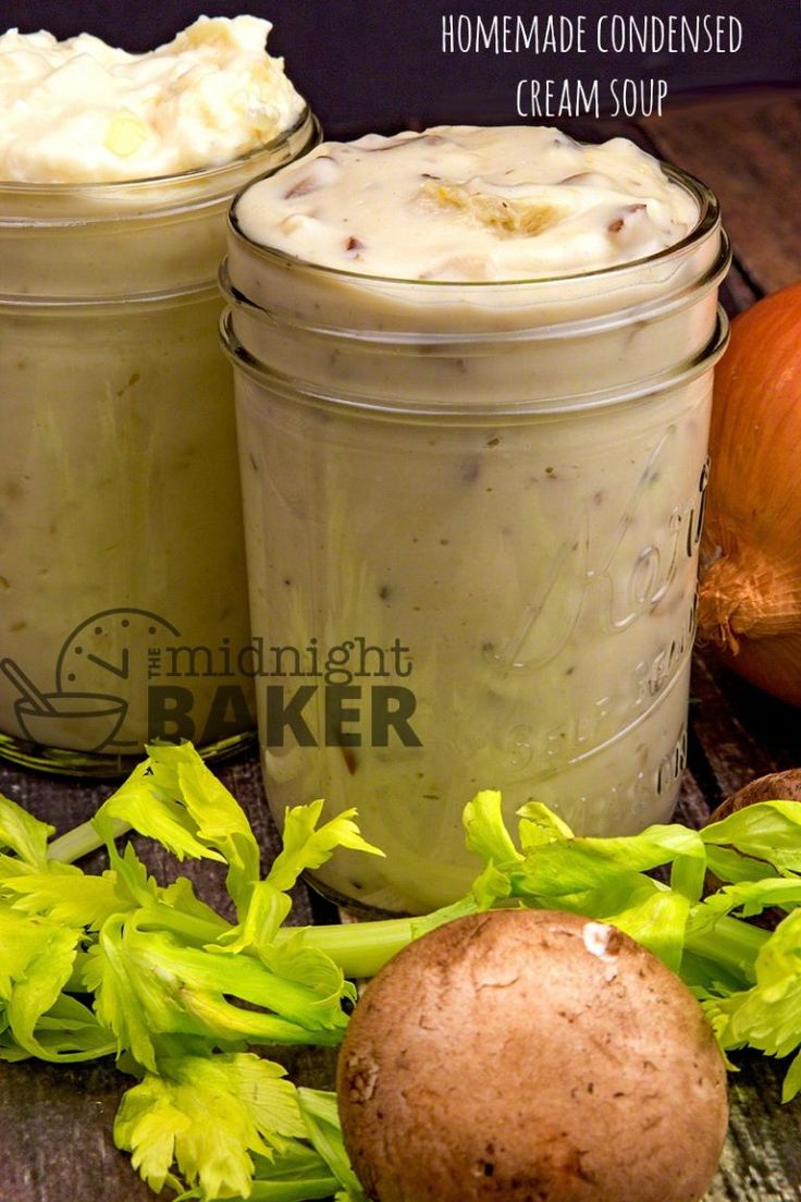 two jars filled with food sitting on top of a table next to vegetables and potatoes