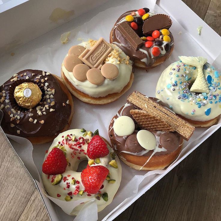 a box filled with lots of different flavored donuts