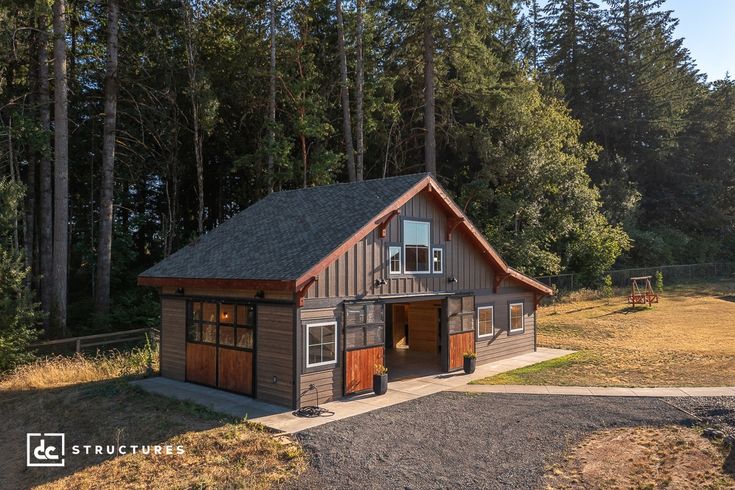 a small wooden building sitting in the middle of a forest with lots of trees around it