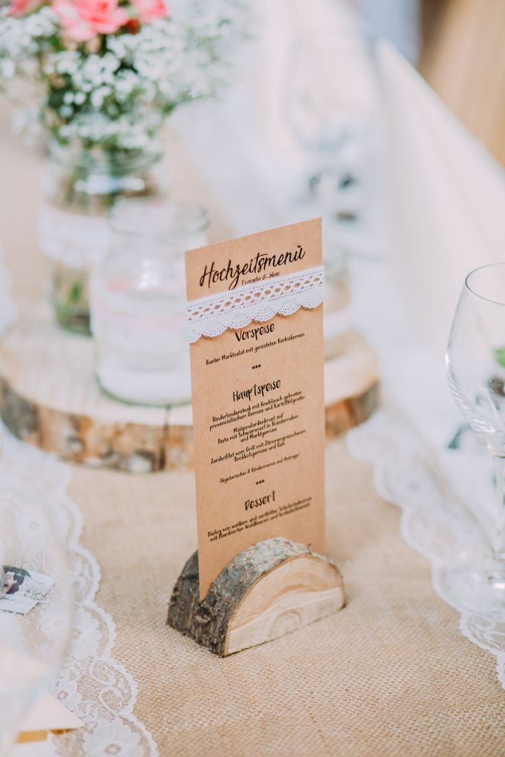 a table with place cards and wine glasses on it