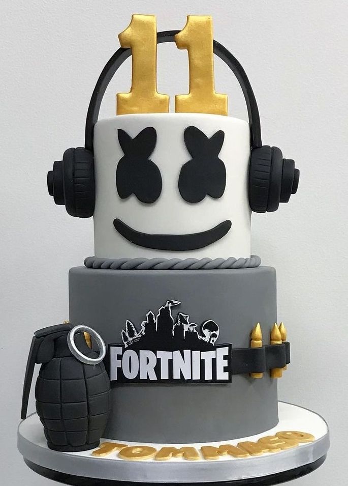 a cake that is decorated to look like a fortnite helmet with headphones on top