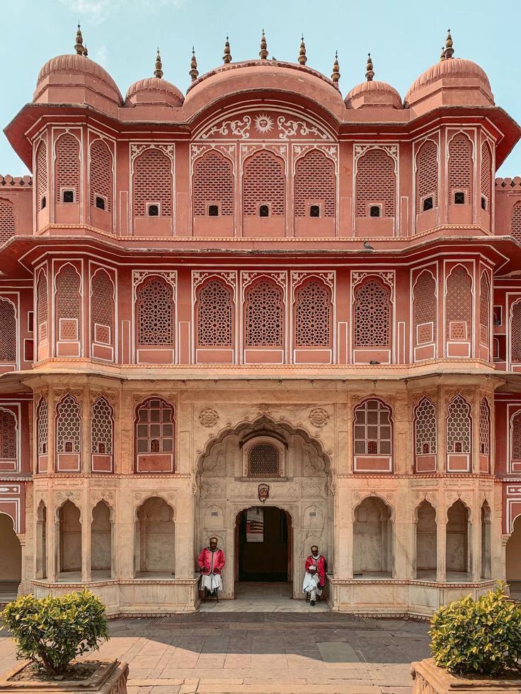 two people standing in front of a large building