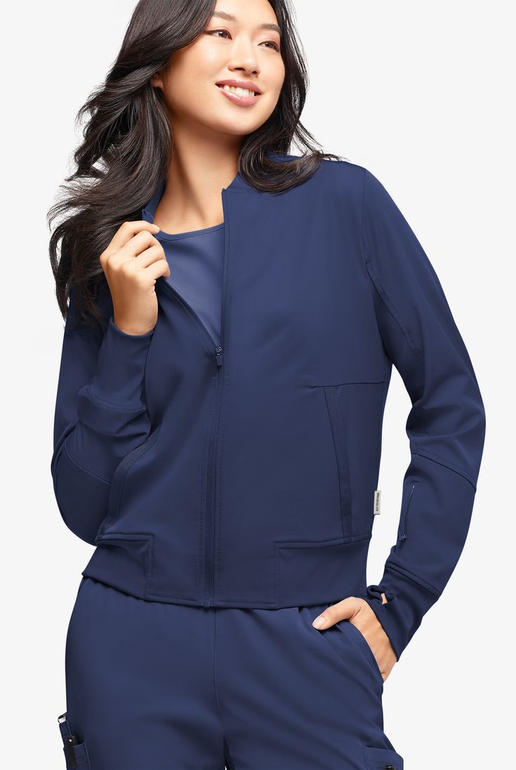 A jacket that’s cool from fabric to style. It’s a classic bomber with so many amazing details: rib-knit cuffs with thumbholes, feminine grosgrain ribbon trim and 4 pockets. It’s even lined through the body for a smooth finish. WhisperLite may be your coolest-feeling scrubs ever. Feather light poplin with wicking and 4-way stretch that also repels lint, fur, and hair. And with extra chic, feminine styling, they look cool too. • Modern fit • Bomber style • Rib-knit collar • Full-length front zippe Versatile Solid Color Long Sleeve Track Jacket, Long Sleeve Versatile Track Jacket, Stretch Solid Outerwear With Ribbed Cuffs, Stretch Fall Outerwear With Side Pockets, Long Sleeve Track Jacket With Pockets For Work, Stretch Long Sleeve Track Jacket With Pockets, Fall Long Sleeve Track Jacket With Elastic Cuffs, Versatile Stretch Outerwear With Ribbed Cuffs, Stretch Crew Neck Outerwear With Ribbed Cuffs