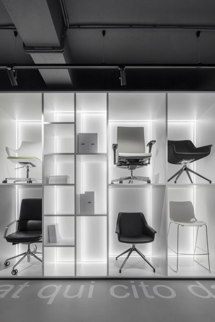 an office space with chairs and desks in the center, all lit up by lights