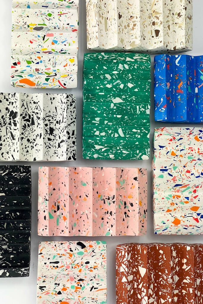 many different colors and shapes of paint splattered on canvases, arranged in rows