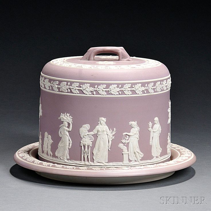 a pink and white porcelain covered dish with figures on it