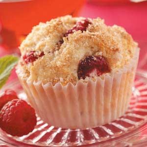 a close up of a muffin on a plate with strawberries