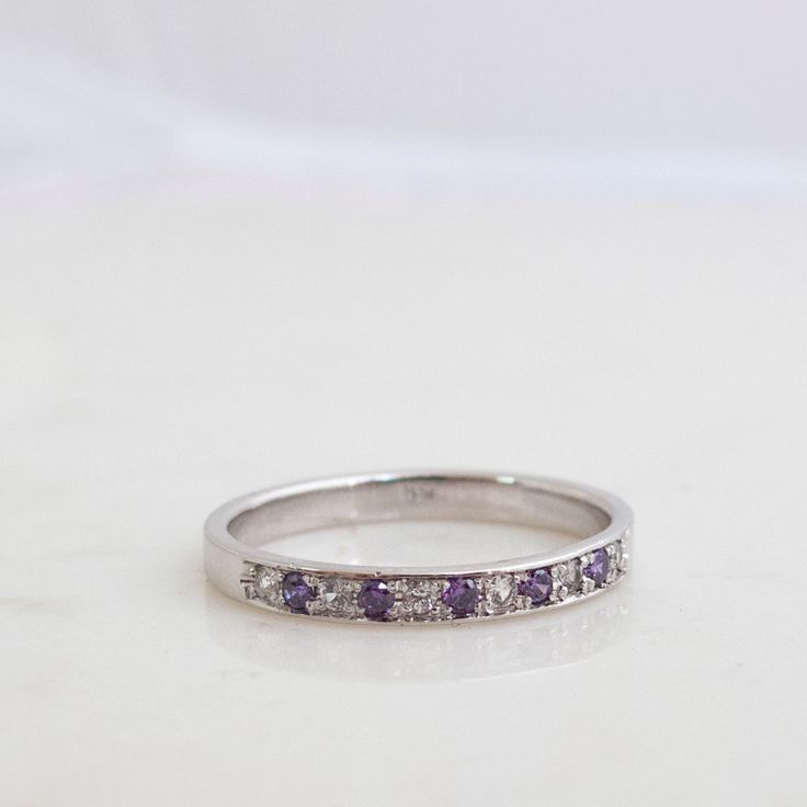 "Beautifully made Simple Half eternity Band Featuring 6 Diamonds and 5 Alexandrite gemstones. Formed as a whole and perfectly round This handmade ring is most Elegant and precious. A real joy to Own, comfortable and Rich in Sparkling presence! Featuring 11 Stones in Total. Six Diamonds (vs) 1.5mm for a Total carat weight of 0.09 Minimum And Five 1.5mm Alexandrite Gemstones (Lab created ones, Real one Are very, Very rare to come by in these small sizes). The Ring weighs approx 3-3.2Grams of Solid White Gold Round Multi-stone Gemstones, Cubic Zirconia Anniversary Gemstone Round Cut, Anniversary Cubic Zirconia Gemstone Round Cut, Round Diamond Birthstone Gemstones, Diamond Birthstone Gemstones, Fine Jewelry Round Sapphire Ring With Channel Set, Fine Jewelry Sapphire Ring With Channel Set, Diamond Multi-stone Stackable Rings Round Cut, Diamond Multi-stone Stackable Rings