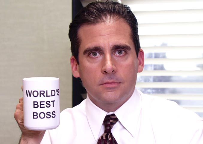 a man holding a coffee mug with the words world's best boss on it