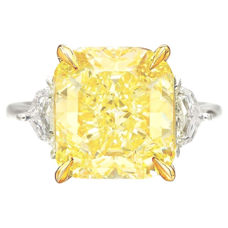 An exquisite 10 carat fancy yellow diamond ring set in platinum and 18 carats yellow gold the ring has been handmade in Italy with two side tapered baguettes also 100% eye clean and full of brilliance! Fancy Yellow Diamond Ring, Radiant Diamond Rings, Graff Diamonds, Orange Diamond, Yellow Diamond Ring, Radiant Cut Engagement Rings, Yellow Diamond Rings, Simulated Diamond Rings, Yellow Engagement Rings