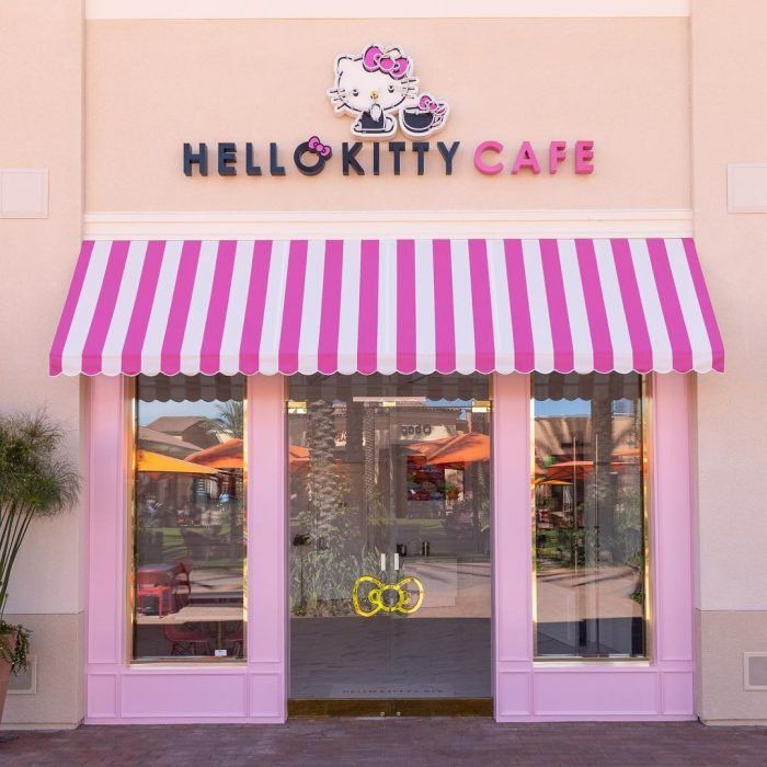 the hello kitty cafe has pink and white awnings on it's windows