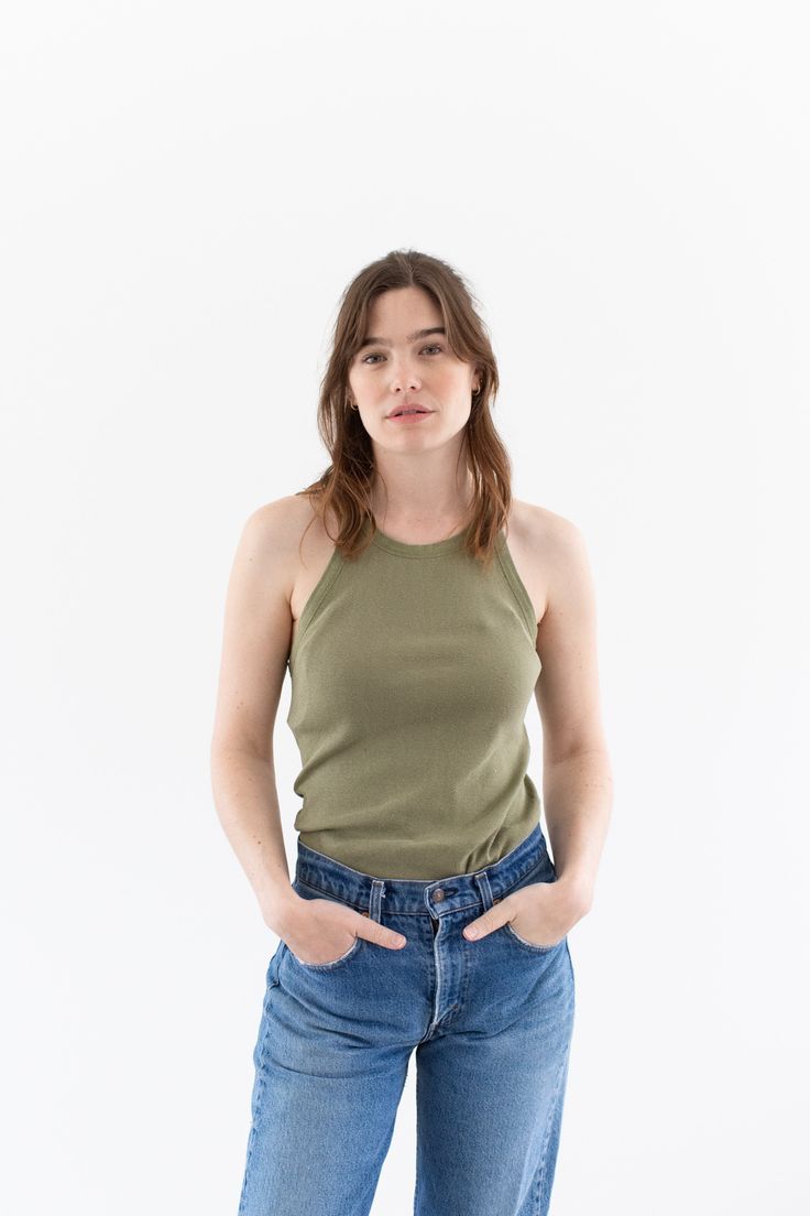 "WW2 Undershirt Tank Top in Olive Green. Low armholes and a flattering neckline. Black faded Letters on back. Material: 100% cotton  |  Made in USA in the 40s. Condition: Good. a few small pin holes - on back..   XSMALL-LONG: Shoulders: 8.5\" | Chest: 14\"  |  Length: 28\" Cassie is 5'8\" and wears a size small top. SHOP http://www.rawsonstudio.etsy.com FOLLOW US + instagram | @_rawson + pinterest | rawson *No Returns. Items are eligible for store credit only. We ask that the buyer ship to provi Fitted Cotton Tank Top With Crew Neck, Fitted Green Everyday Tops, Green Fitted Top For Everyday, Everyday Fitted Green Tops, Fitted Tank Top For Everyday Wear, Fitted Green Cotton Top, Olive Green Tank Top, Undershirt Tank Top, Green Tank Top