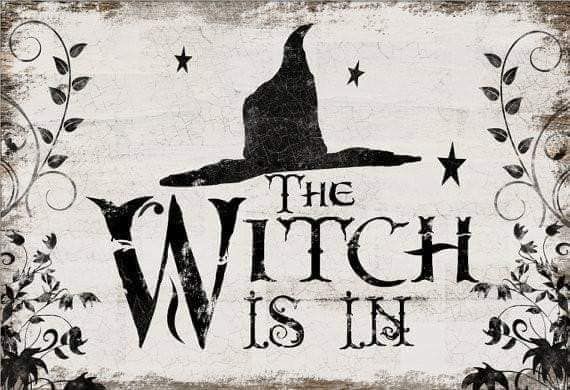 a wooden sign that says the witch is in