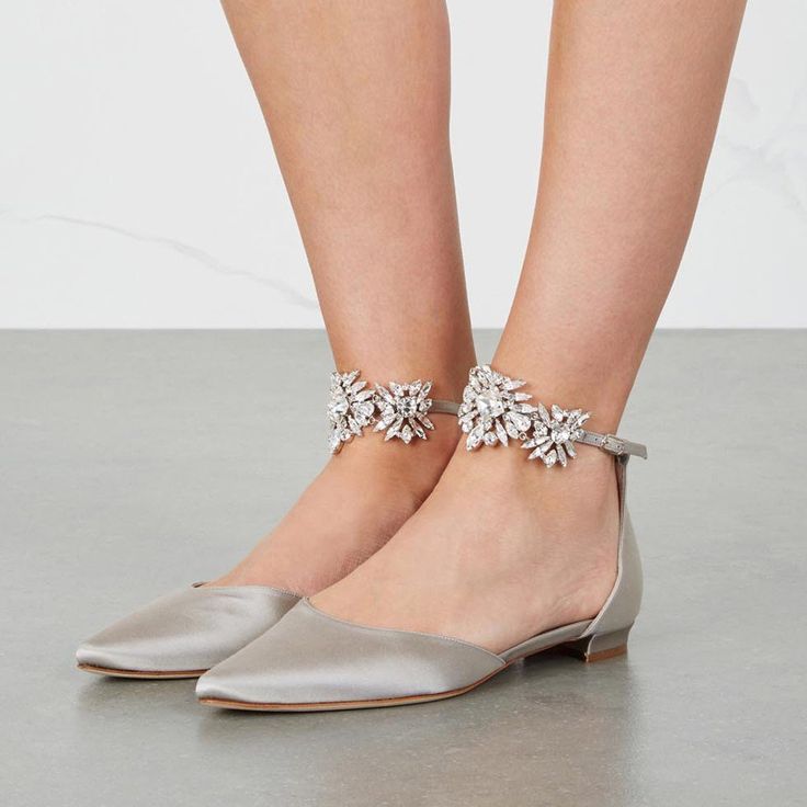 Elevate your casual chic look with our Grey Satin Rhinestone Embellished Ankle Strap Pointed Toe Flats. These flats combine comfort and style, featuring a sleek satin finish, sparkling rhinestone embellishments, and a sophisticated pointed toe. Handcrafted US sizing. Fits true to size. Sleek satin finish for a luxurious and stylish appearance. Rhinestone embellishments add a touch of sparkle and glamour. Pointed toe design for a modern and chic silhouette. Ankle strap detail enhances the overall fashionable look. Versatile grey color complements various outfits. Ideal for both casual and semi-formal occasions. Grey Wedding Shoes, Country Shoes Boots, Champagne Wedding Shoes, Best Bridal Shoes, Strap Flats, Wedding Boots, Manolo Blahnik Heels, Bridal Shoes Flats, Grey Wedding