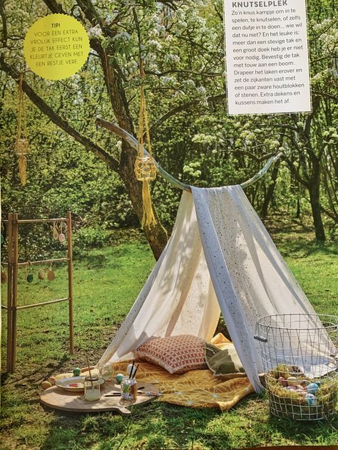 an image of a tent set up in the grass with trees and other items around it