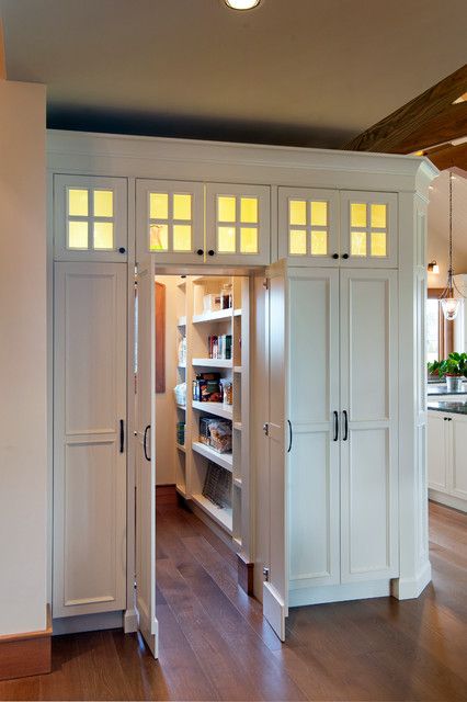 an open pantry with several doors and shelves