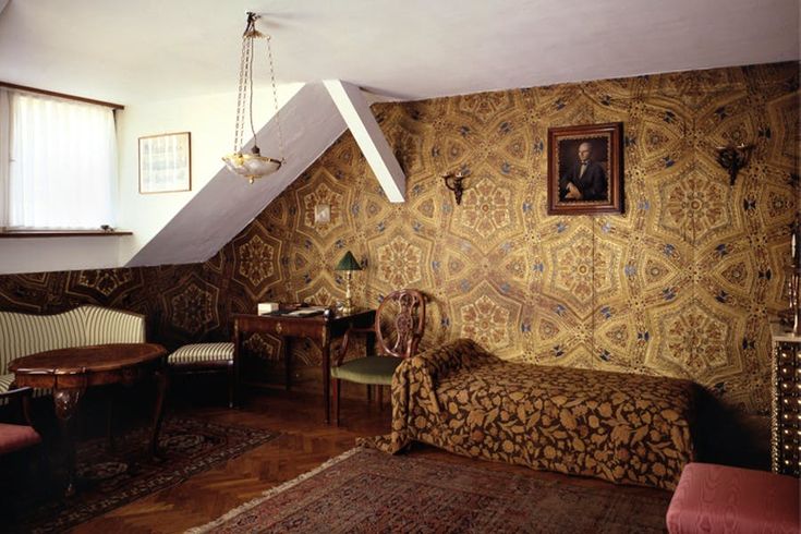 an old fashioned bedroom with antique furniture and wallpaper