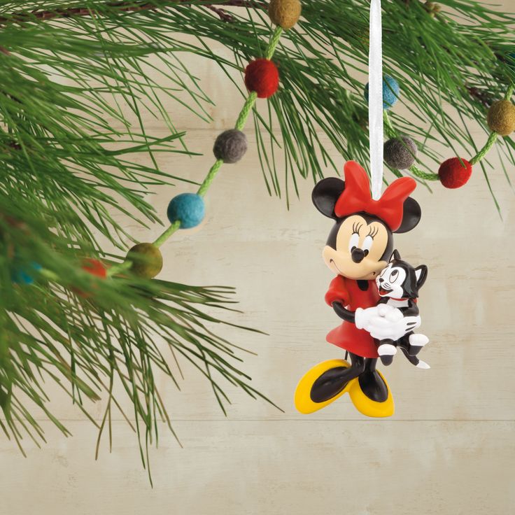 a mickey mouse ornament hanging from a christmas tree