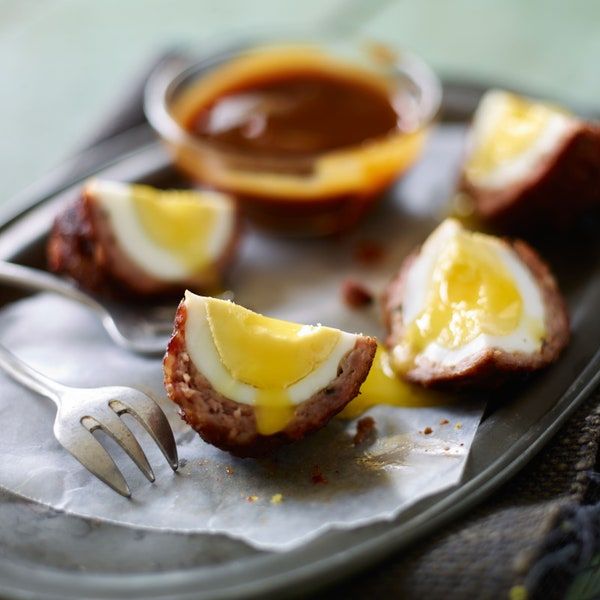 an egg and cheese stuffed meat is on a plate with a fork