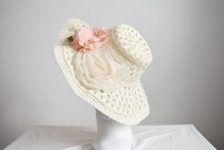 "Description and Measurements: Off white floppy sunhat with two big flowers on it. 5\" wide band, fits a 21-22\" head. Tag: No label Condition: Excellent Follow along on instagram @lovecharlesvintage" Retro White Sun Hat For Spring, Retro White Sun Hat For The Beach, Retro White Sun Hat For Beach, White Wide Brim Mini Hat For Vacation, Handmade Flower Hats For Summer, White Brimmed Mini Hats For Vacation, White Retro Sun Hat With Curved Brim, Retro White Sun Hat With Curved Brim, White Wide Brim Mini Hats For Summer