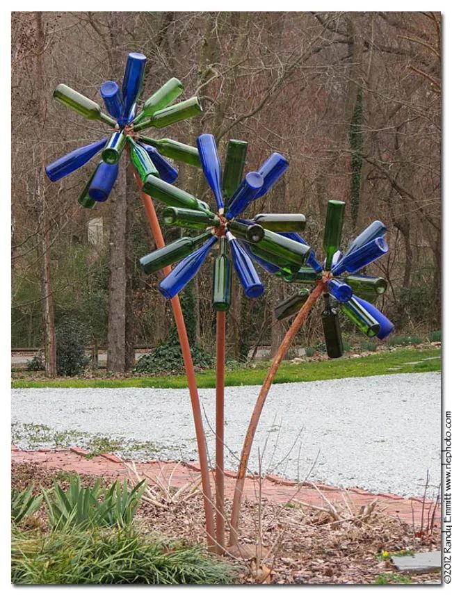 three different pictures of blue and green windmills in front of a road with trees