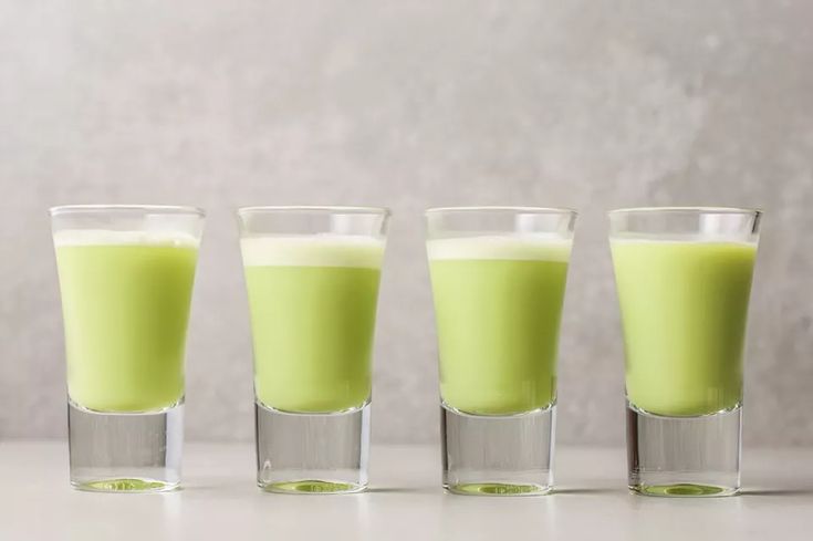 three shot glasses filled with green liquid