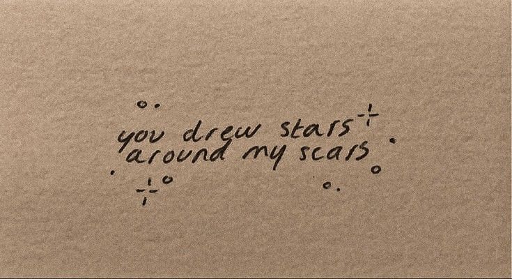 the words you drew starts around my scars are written in black ink on brown paper