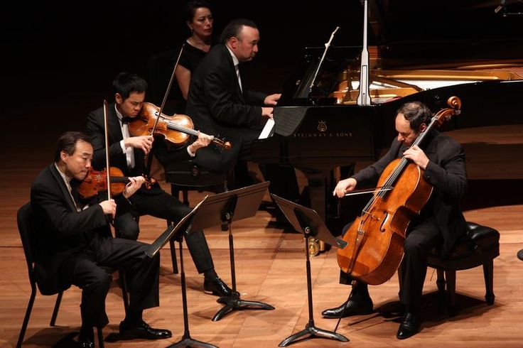 an orchestra playing music on stage with musical instruments