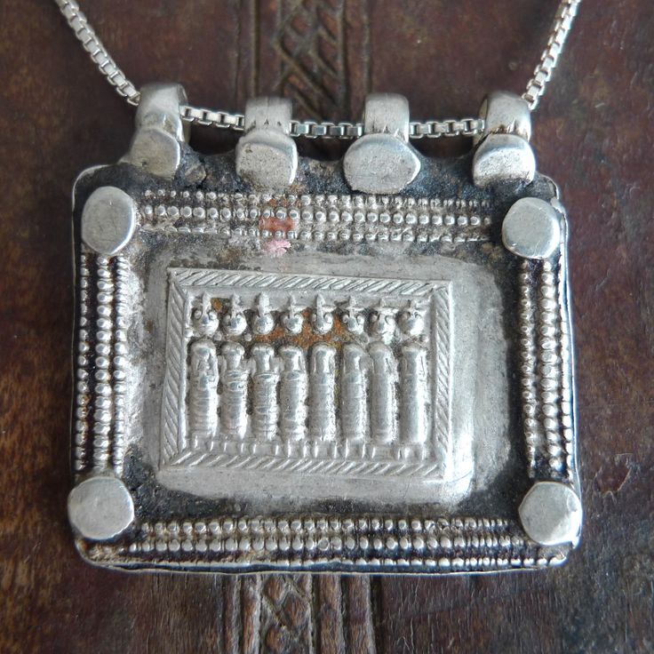 Wonderful tribal pendant from India. Silver tribal square pendant from India Rough and powerful jewelry from the Gujarat state. A depiction of the eight mothers (ashtamatrika: Brahmanai Bhairavi Chamundi Vaisnavi Varahi Mahesvari Indrani Kaumari) personified shakti powers of the Devas (Gods). The pendant has been reshaped by silver masters from its original version to transform it into a charm as shown in the 4th picture. Silver chain is included. Pendant: 3.7 x 3.5 centimeters Weight: 10 grams Traditional Rectangular Necklace For Festivals, Traditional Silver Necklace With Square Pendant, Traditional Silver Rectangular Pendant Jewelry, Handmade Traditional Rectangular Necklace, Traditional Handmade Rectangular Necklace, Etched Pendant Jewelry For Rituals, Traditional Jewelry With Large Square Pendant, Traditional Handmade Necklace With Rectangular Pendant, Handmade Traditional Necklace With Rectangular Pendant