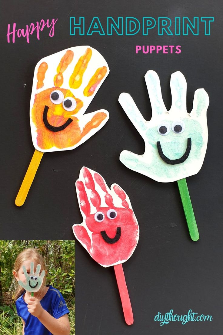 three handprint puppets with faces and hands painted on them