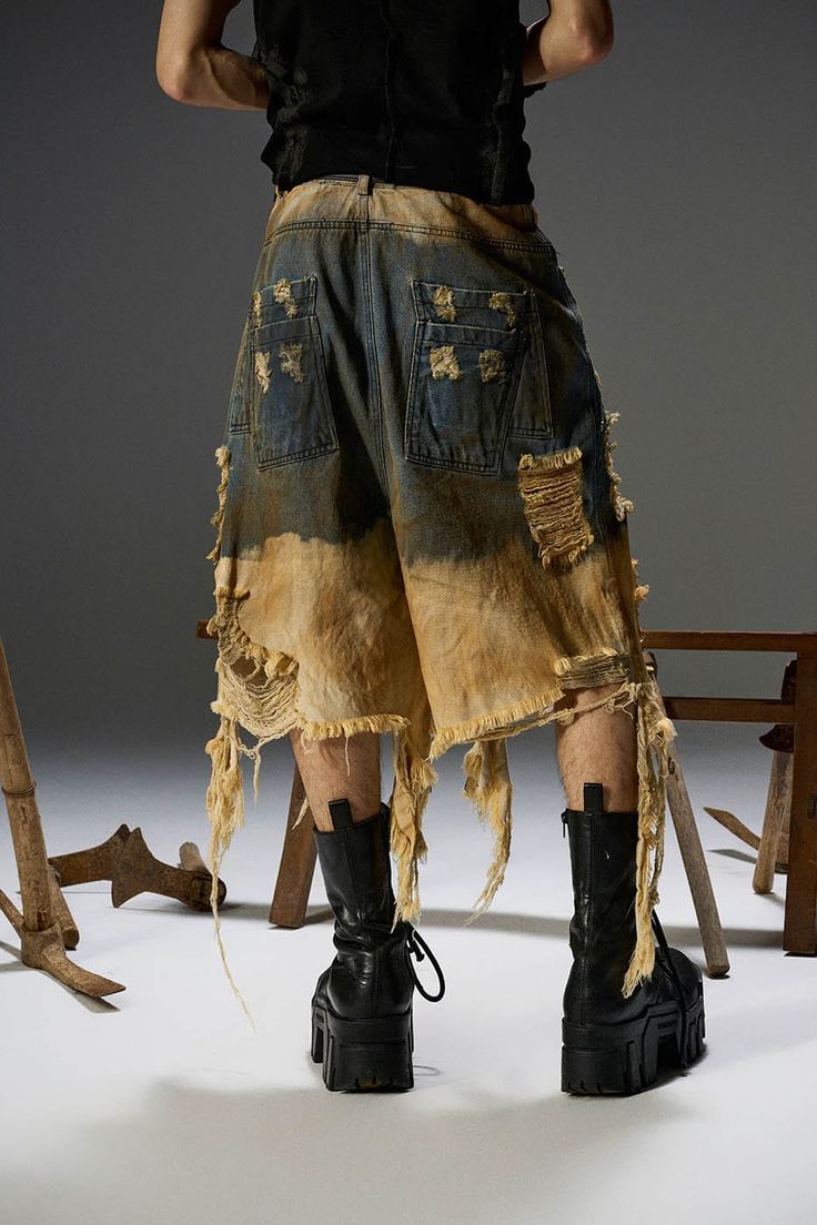 The Rotten Shorts seamlessly blend street style with avant-garde flair. These shorts feature a unique dirty dye treatment on the lower half, giving them a distinctive and edgy look. The all-over distressed design includes large, intentional rips and tears, while the frayed tassel details at the hem add to their rugged appeal. Made from premium 100% cotton fabric, these shorts promise both comfort and durability. The oversized fit enhances the relaxed, contemporary silhouette, making them a stand Avant Garde Street Style, Nature Streetwear, Distressed Clothes, Unconventional Fashion, Unique Styling, Edgy Look, Stage Outfits, Look Cool, Diy Fashion