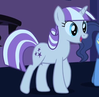 two ponies standing next to each other in a room