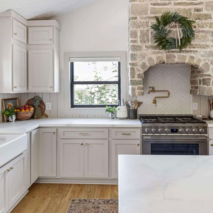 a kitchen with white cabinets and an oven