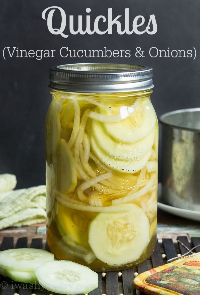 a jar filled with pickles sitting on top of a table