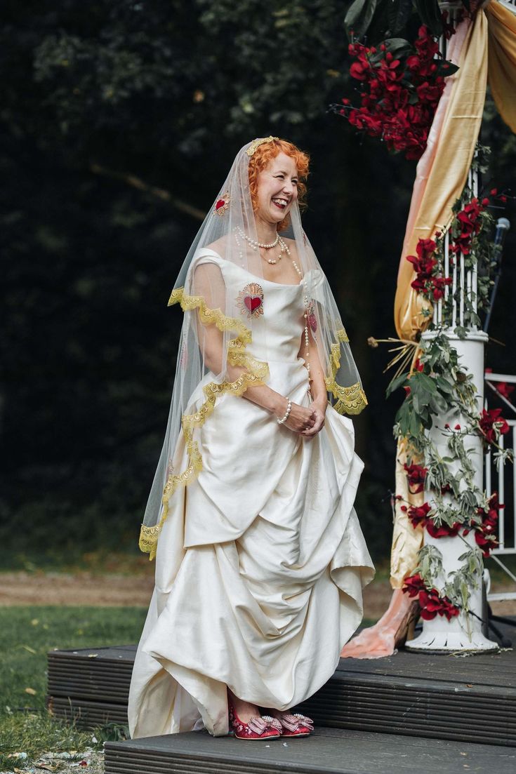 a woman in a wedding dress standing on steps