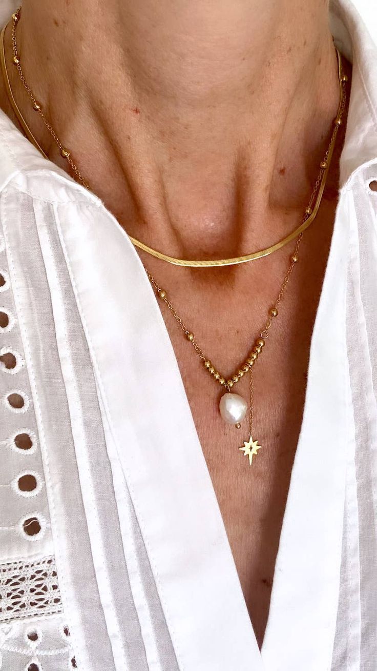 It's all in the detail for this gorgeous two-layer necklace in 14K gold-plated stainless steel, adorned with a Freshwater Pearl and a hanging star. It's perfect for dressing up or adding a touch of glamour to your everyday style Length: 15 to 17 inches with extender Elegant Gold Necklace With Star Charm, Elegant Gold Chain Necklace With Star Charm, Gold Plated Necklaces With Star Charm, Layer Necklace, Dressing Up, Pitcairn Islands, Guinea Bissau, Everyday Style, Layered Necklaces