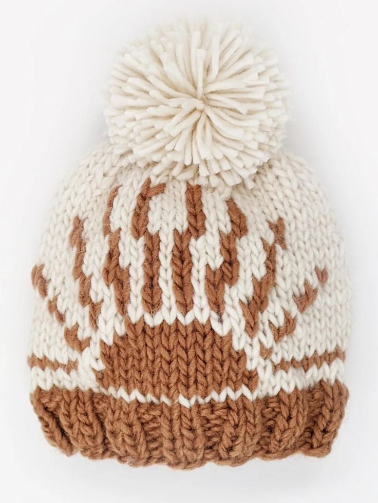 Retro looking Sunrise is hand knit in Pecan brown hued yarn on a natural ground and topped with a pom pom for fun. Knit in chunky, soft yarn to keep little heads warm. Our hats are partially knit from recycled, sustainable Polyester yarn made from plastic bottles. We are on a mission to help reduce the world's plastic pollution problem ♻• Hand Knit • 60% Acrylic, 40% Recycled Polyester• Hand Wash Cozy Brown Crochet Hat With Soft Knit, Cozy Brown Chunky Knit Beanie, Brown Crochet Knit Hat For Cold Weather, Brown Chunky Knit Cozy Beanie, Brown Knit Crochet Hat For Cold Weather, Cozy Brown Knitted Hat, Cozy Warm Brown Crochet Hat, Brown Soft Knit Yarn Hat, Brown Chunky Knit Hat For Fall