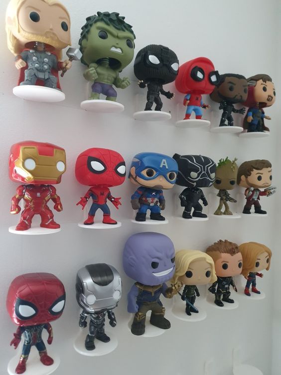 the avengers pop - up figures are lined up on a white shelf in front of each other