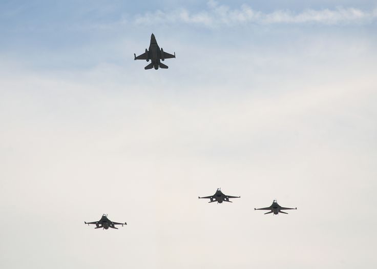 four fighter jets are flying in the sky