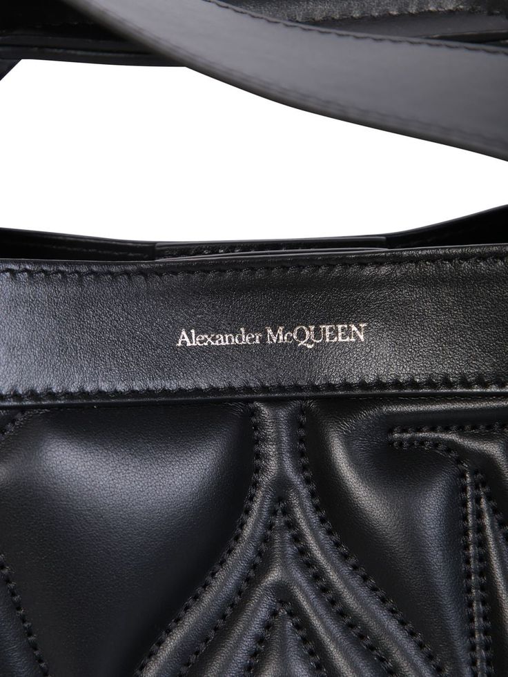 This Alexander McQueen bag boasts a structured silhouette defined by sharp linesQuilted. Embroidered logo on the front. Magnetic fastening. Main compartment. Adjustable detachable shoulder strap. Flat top handles. Color: blackWidth: 43 cm Height: 30 cm Depth: 14 cm Strap: 50 cmMaterial: 100% Calf LeatherMade in ItalyGender: WOMENMaterial: 100% CALF LEATHERColor: BLACKMade in: ITProduct ID: 709566 1BLFU 1000*Import tax/duty will be calculated at checkout (If applicable)