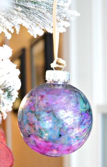 a glass ornament hanging from a christmas tree