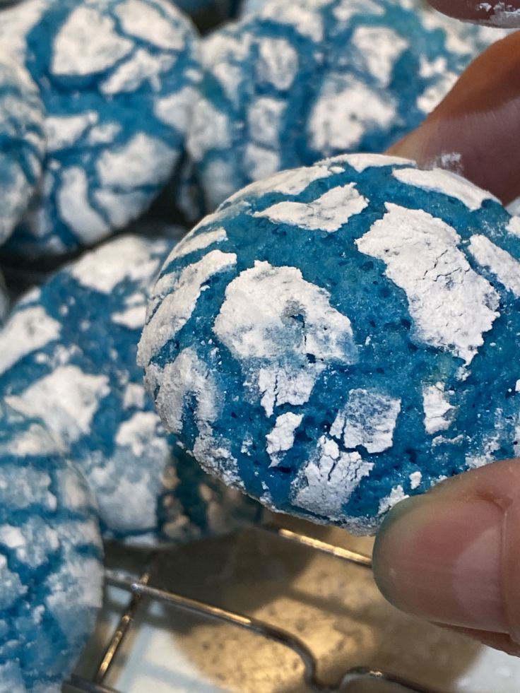 a person is holding a blue and white cookie