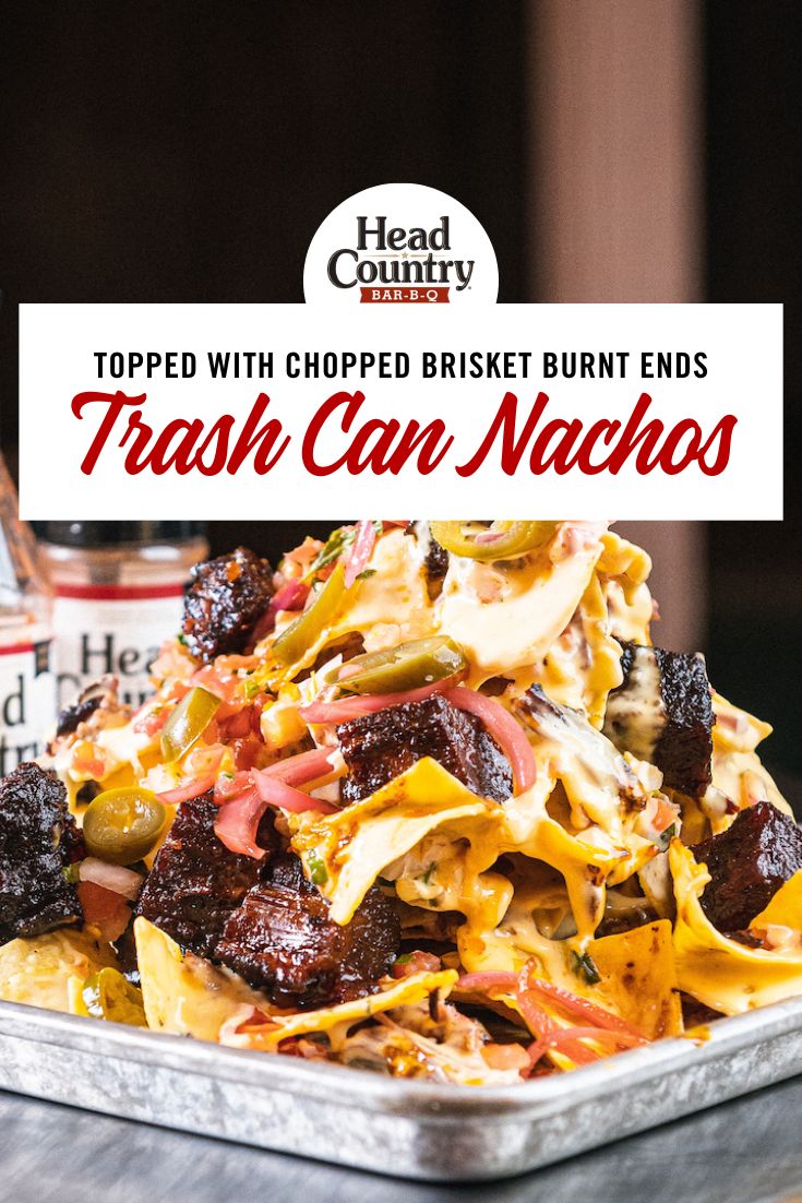 a close up of a plate of food with text overlay reading topped with chopped brisket burnt ends trash can nachos