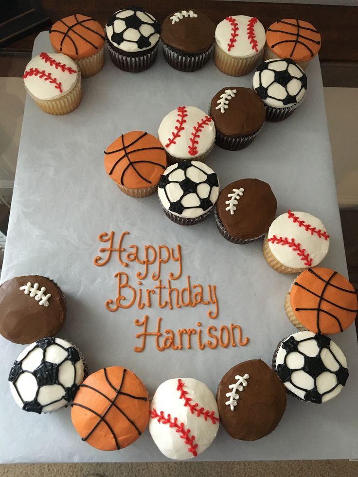 a birthday cake with cupcakes decorated like sports balls and the words happy birthday harrison