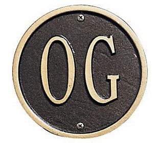 a black and gold metal sign with the word'o'in large letters on it